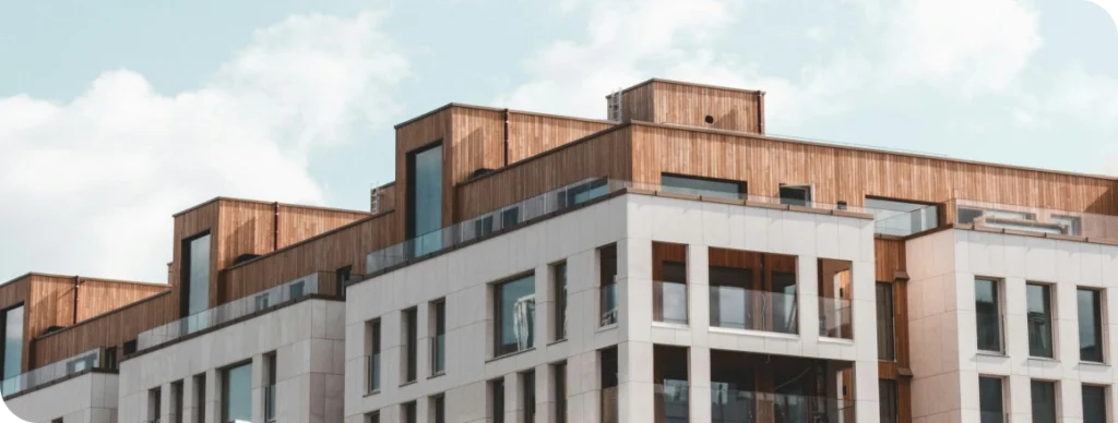 Example Resource Post 1 Apartment building with a cloud-filled blue sky in the background.